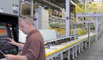 image of a hormann factory worker producing guide rails for garage doors