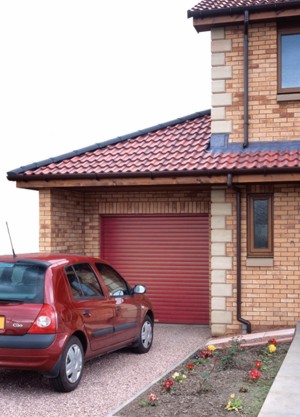 Samson Suparolla in red installed onto house with family car in driveway