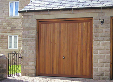 Cedar Bakewell timber up and over garage door with vertical tongue and groove boarding