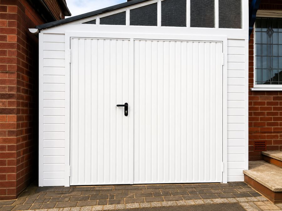White sectional garage door with integrated pedestrian access door